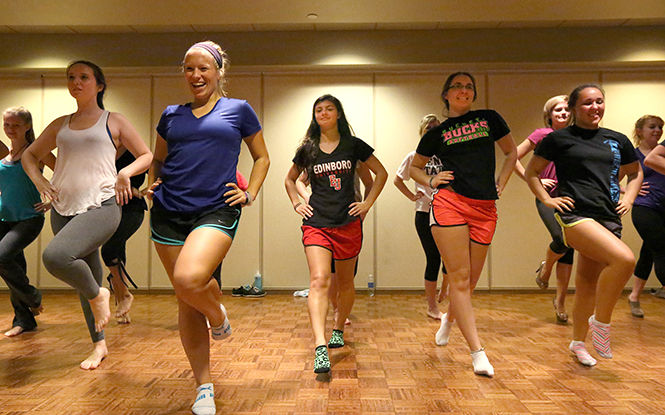 Kent State students participate in the cardio striptease class taught by Carol Eden on the ballroom balcony in the Student Center on Monday, Oct. 13, 2014.