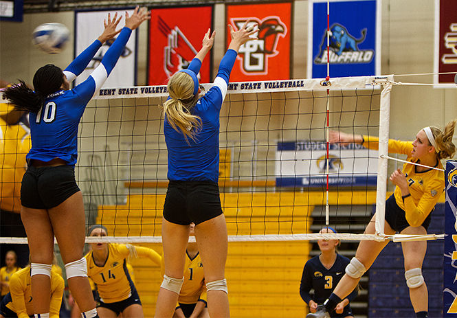 Kelsey Bittinger, outside hitter, hits the ball against the University at Buffalo to gain a point at the game Saturday, Oct. 4, 2014. The Flashes won 3-0.