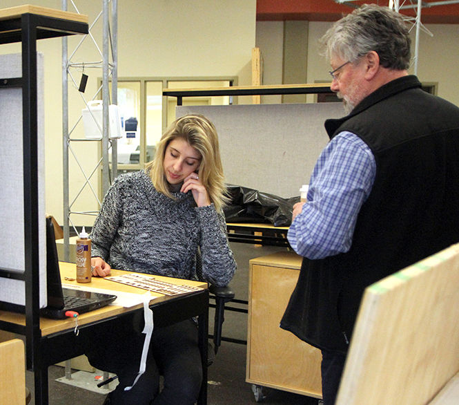 Architecture professor Charles Harker takes a look at senior architecture major Danielle Joness project during her studio time Wednesday, Oct. 8, 2014.