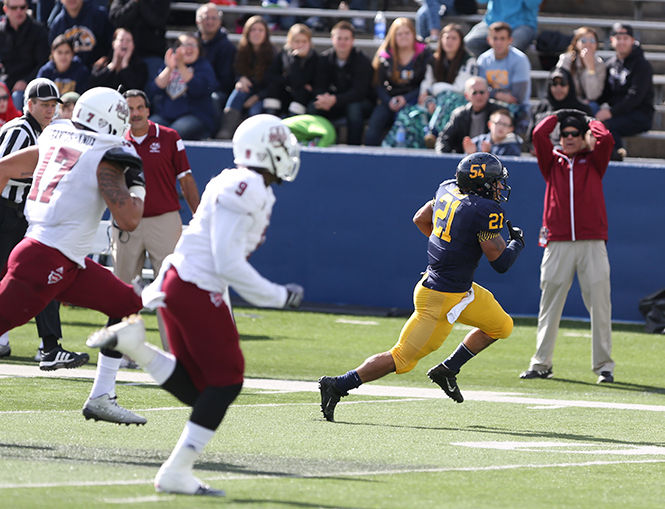 Senior running back Anthony Meray runs down the field at the game against the University of Massachusetts on Saturday, Oct. 11, 2014. The Flashes lost, 40-17, bring their season to 0-6.