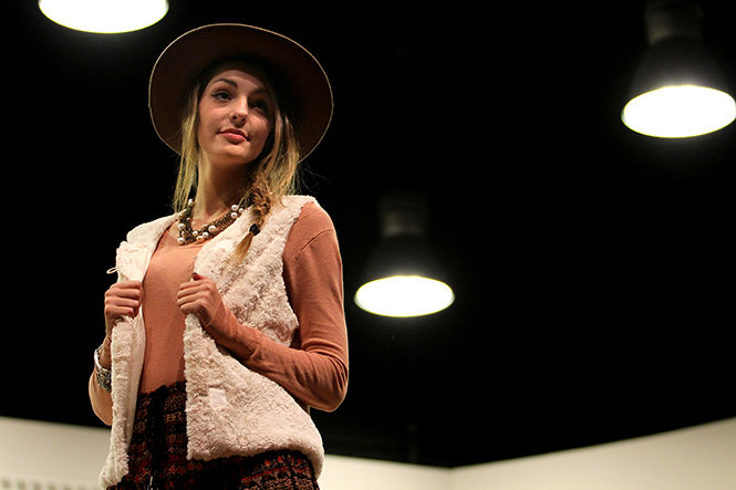 A model looks out to the audience while walking across the stage during the Art of Contrast Fashion Show in the Schwartz Center Friday, Oct. 10, 2014.