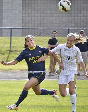 Kent State University senior forward Calli Rinicella struggles against Akron's Abby Gindlesberger to gain possession of the ball in the game Sunday, Sept. 28, 2014. The Flashes went on to win 3-0 and kept the Zips from taking a single shot on goal for their first MAC win of the season.