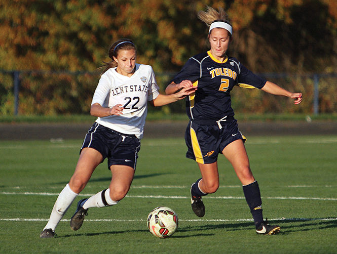 Freshman midfielder Abbie Lawson fights for the ball against Toledos Megan Connor to the ball during a game Friday, October 24, 2014. The Flashes won 3-0.