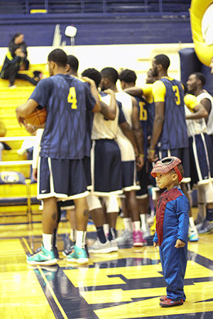 Two-year-old Kent resident Ramar Richmond, dressed as Spider-Man, plays on the gym floor of the M.A.C. Center during Hoops n Halloween on Sunday, Oct. 26, 2014.