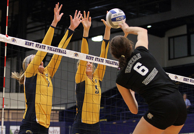 Kent States junior Kelly Hutchison and senior Liz Reikow jump together to block the ball during a game against Western Michigan on Saturday, Oct. 25, 2014. The Flashes won, 3-1.