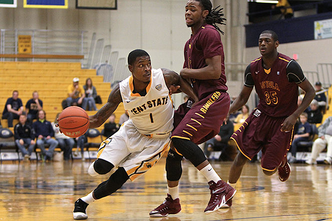 Senior guard Kris Brewer protects the ball from Loyola University in the M.A.C. Center on Saturday, Nov. 29, 2014. The Flashes lost, 69-61.
