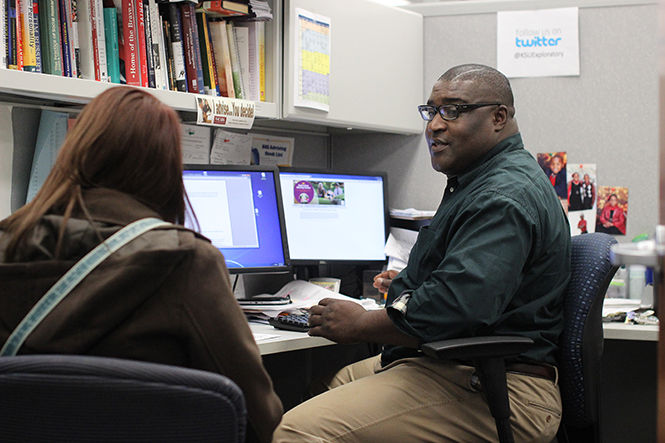 Academic Advisor H. Bate Agbor-Baiyee discusses scheduling with a student during an advising appointment on the 5th floor of the Kent State Library on Thursday, Nov. 13, 2014.