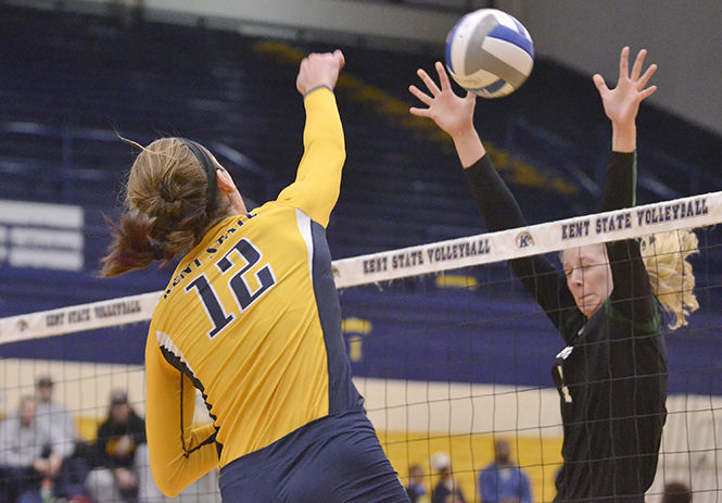 Kent States senior middle blocker Bridget Wilhelm spikes the ball during the game against MAC opponents Ohio University in the M.A.C. Center on Thursday, Oct. 30, 2014. 