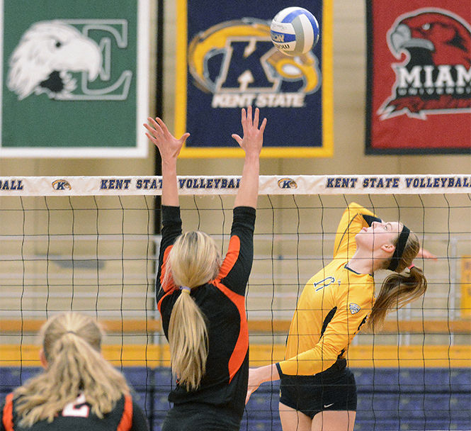 Kent State freshman outside hitter Kelsey Bittinger spikes the ball toward a Bowling Green State University player during their final game of the regular season in the M.A.C. Center on Saturday, Nov. 15, 2014. The Flashes lost to Miami University this weekend, eliminating them from the Mid-American Conference tournament.