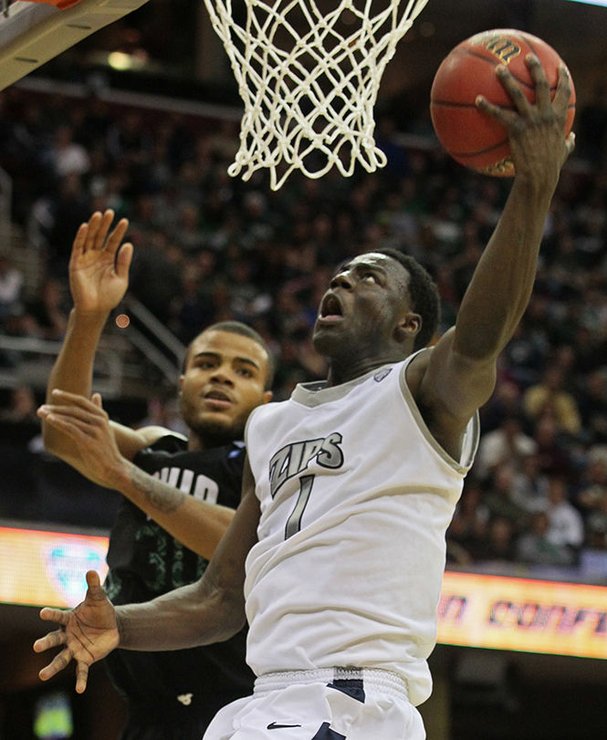 Akrons Demetrius Treadwell, right, takes a second-half shot as Ohios Darius Holsten defends in the Mid-AmericanTournament championship game at Quicken Loans Arena in Cleveland, Ohio, on Saturday, March 16, 2013. The Zips won, 65-46. (Phil Masturzo/Akron Beacon Journal/MCT)