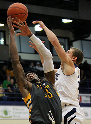 Forward Jimmy Hall reaches to grab the ball in a game against Malone University in the M.A.C. Center on Tuesday, Nov. 18, 2014. The Flashes beat the Pioneers, 62-52.