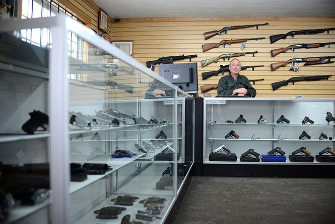 Sporting+Defense+LLC+owner+Larry+John+speaks+to+customers+on+Saturday%2C+Jan.+12.+John+opened+the+gun+shop+in+Brimfield%2C+just+outside+of+Kent%2C+in+August+of+2012.+Lately%2C+John+says+sales+have+been+higher+than+ever%2C+especially+since+the+gun+control+debate+resulting+from+the+recent+school+shootings+in+Connecticut.