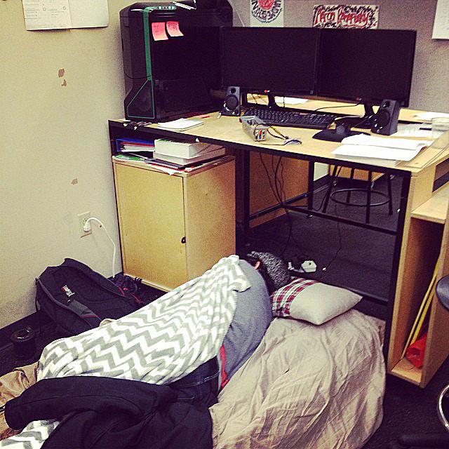 Senior architecture major Aaron Kanapesky sleeps on an air mattress beneath his desk in the Tri-Towers Studio. 