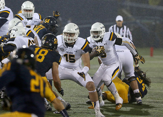 The University of Toledo runs a play against the Kent State during the game Tuesday, Nov. 4, 2014. The Flashes lost 20-30.