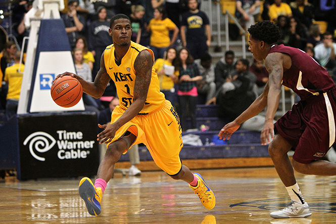 Senior Guard Kris Brewer dribbles the ball against Southern Illinois University in the M.A.C. Center on Friday, Nov. 21, 2014. The Flashes won, 74-51.