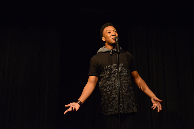 Laurent Che, 22, performs his spoken word piece at the first Poetry Slam presented by The Wick Poetry Center, Black United Students and Luna Negra Magazine on Thursday, Nov. 20, 2014. Around 20 student poets performed to a full theater in Oscar-Richie Hall.