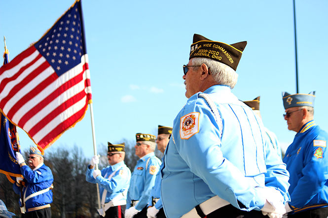 Veterans in uniform raise the flag during a Veterans Day ceremony hosted by PARTA and the Kent State University Hotel and Conference Center on Veterans Day, Tuesday Nov. 11, 2014.