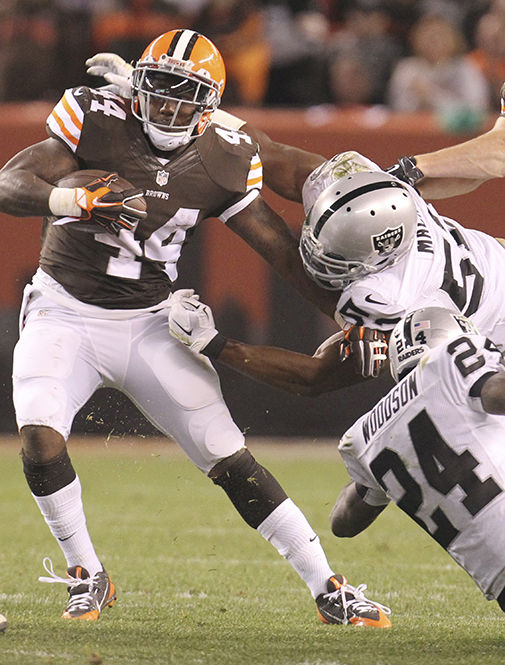 Cleveland Browns Ben Tate is taken down by Oakland Raiders Khalil Mack and Charles Woodson (24) on Sunday, Oct. 26, 2014, at FirstEnergy Stadium in Cleveland, Ohio. The Browns won the game 23-13. (Phil Masturzo/Akron Beacon Journal)