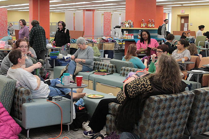 Kent State students, faculty and member of the Kent community volunteer at the 12-hour Knit-A-Thon to help knit hats and scarfs for those in need in the library on Friday, Nov. 14, 2014.