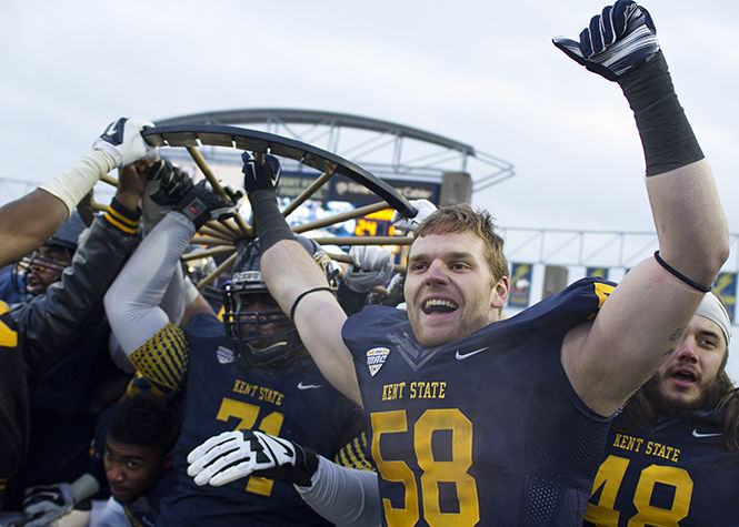 The Flashes celebrate after winning the Wagon Wheel game against Akron on Friday, Nov. 28, 2014 at Dix Stadium. The final score was 27-24.