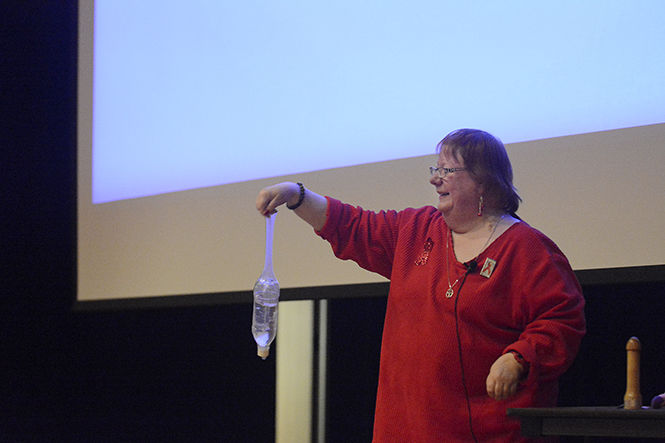 Kat Holtz, HIV specialist for the Portage County Health Department, demonstrates how large a small-sized condom is during her presentation about AIDS prevention and the United Nations vision of Getting to Zero with HIV on Dec. 1, 2014. Holtz said that if a guy ever claims his penis is too big for a condom, he should see this demonstration.