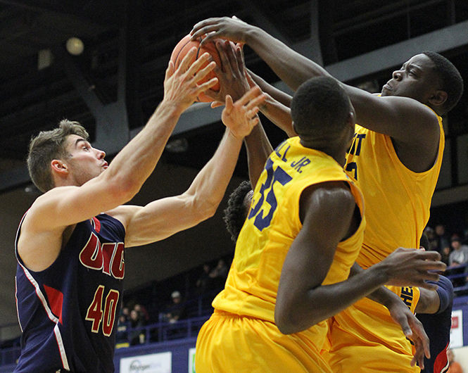 Freshman forward Raasean Davis tries to grab the rebound from University of Illinois at Chicagos Jake Wiegand during a game Saturday, Nov. 22, 2014. The Flashes won, 78-60.