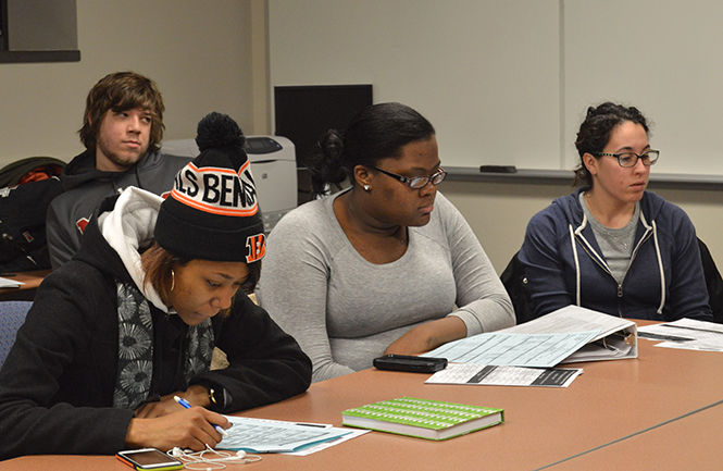 Kent State’s feature film pre-production class reviews forms called call sheets on Thursday Jan. 22, 2015. Call sheets will be used during an upcoming production.