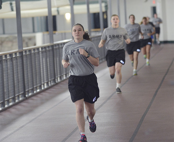  The Kent Stater Cadet Ellie Milner, a senior psychology major, runs two miles around the track inside the Student Recreation and Wellness Center as she trains with fellow Kent State Army ROTC cadets early Friday Jan. 23, 2015.