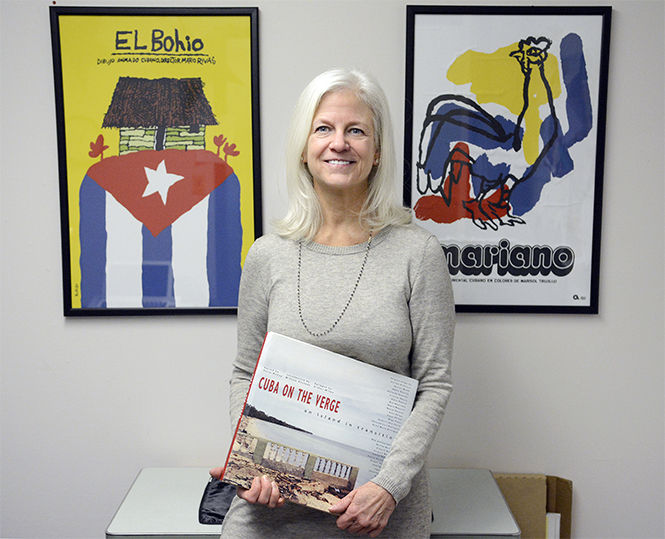 Anne Morrison, professor of Lifespan Development and Education Sciences, stands in front of posters for Cuban films “El Bohio” (1984) and “Mariano” (1981) in her White Hall office Wednesday, Jan. 21, 2015.