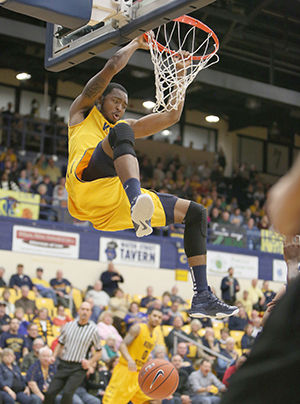 Kent State junior center Khaliq Spicer dunks the ball during the Flashes 67-60 win over the Toledo Rockets in the M.A.C. Center Wednesday, Jan. 21, 2015.