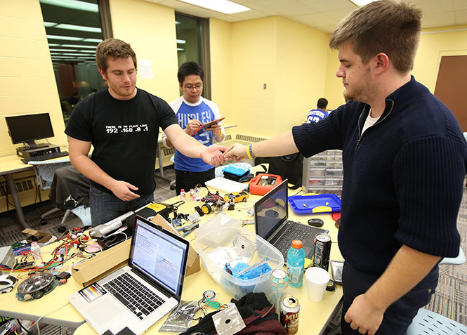 The Kent State Robotics Team works on its robot Friday, Oct. 24, 2014, for the first night of Kent Hack Enough, a two-day Hackathon hosted by HacKSU on the fourth floor of the University Library.
