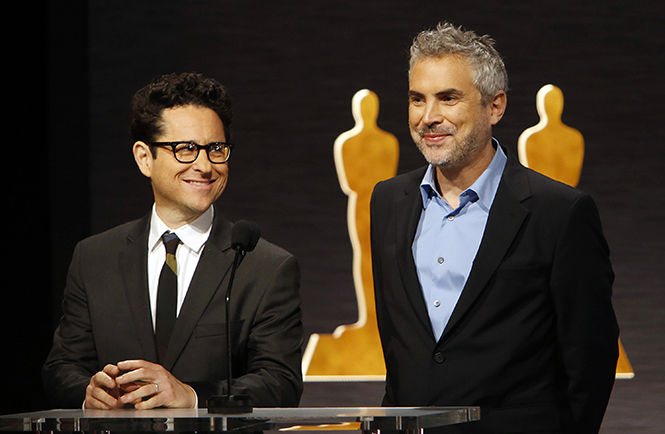 Directors J.J. Abrams, left, and Alfonso Cuaron announce the nominations for 11 of 24 categories for the 87th Academy Awards from Beverly Hills on Thursday, Jan. 15, 2015 in Los Angeles.