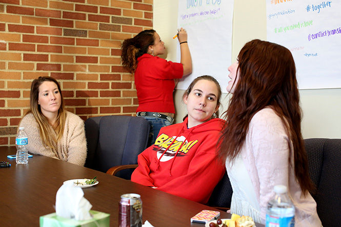  A group of Kent State students discuss possible mantras and ideas for the new Student Mediation Services, which had its opening day on Tuesday, Jan. 27, 2015 in the Twin Towers residence halls.