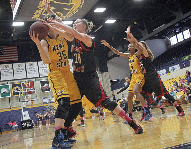 Kent State University freshman forward Jordan Korinek tries to hold on to the ball against Northern Illinois Universitys senior Jenna Thorp in the M.A.C. Center on Saturday, Feb. 14th, 2015. The Flash won 54-52 snapping an 8 game losing streak and bringing their record to 4-19.