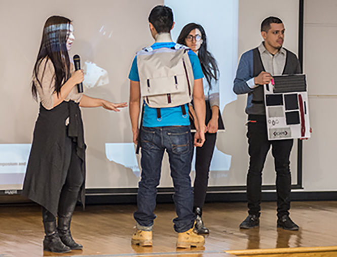 Team Roame explains the prototype of its design at the finalist presentations of the Fashion/Tech Hackathon event hosted in Rockwell Hall on Sunday, Feb. 1, 2015. Roame won first place and a $1,500 award with the design of a backpack that also acts as a hands-free navigational device. The 36-hour event challenged students to combine fashion with technology using resources such as the textile lab available in Rockwell Hall as well as their imaginations.