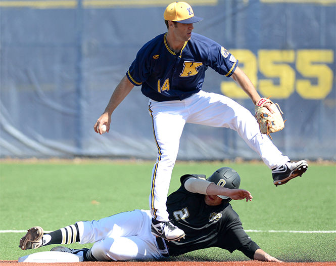 Junior Sawyer Polen tags out opponent Trent Pell before throwing the ball to first and making a double play during a doubleheader game against Oakland University at Schoonover Stadium on April 1, 2014.
