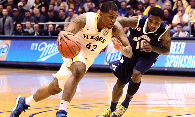 Senior forward Darren Goodson attempts to defend the ball from an Akron player at the game Sunday, Feb. 2, 2014. The Flashes are set to face the Zips again this Friday, Mar. 7, 2014 at the University of Akron. It is the last game before the M.A.C. Championship.