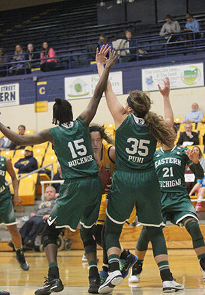 Kent State freshman forward Jordan Korinek is blocked by two Eastern Michigan University players in the M.A.C. Center on Feb. 4, 2015. The Flashes were defeated by the Eagles, 53-70, dropping their record to 3-17.