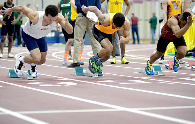 Kent State sophomore Devin Monroe (left) leaves the blocks for the 60-meter dash at the Track and Field Invitational in the Kent State University Field House on Saturday, Feb. 21, 2015. Monroe placed second in the 60-meter dash with a time of 6.95 seconds.