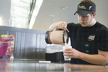 Daniel Conte, a mathematics major, makes a smoothie at the rec center on Tuesday Feb. 24, 2015. Summit Street Cafe, located inside the Rec, serves smoothies, fruits, juices, and other snacks.