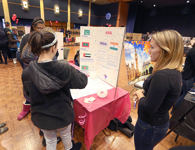 The Kent Stater Members of Centennial Court E and F interhall council talk about the Holi Day, an Indian Hindu festival, during the Celebration of Nations put on by the Kent Interhall Council in the Student Center Ballroom on Monday, Feb. 9, 2015.