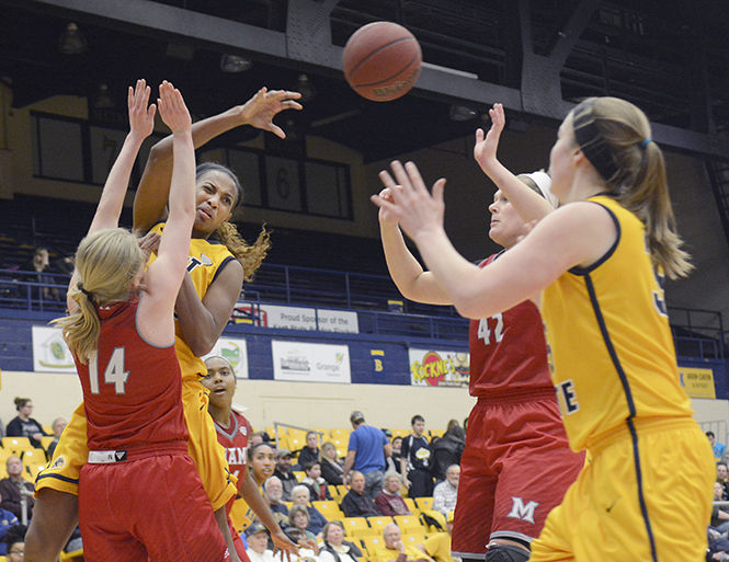 Senior center CiCi Shannon tries to pass the ball through heavy Miami defensive coverage in the M.A.C. Center on Tuesday, Feb. 11, 2015. The flashes were only down by 6 at the half, but fell flat the second half to fall to Redhawks 69-53, dropping their record to 3-19.