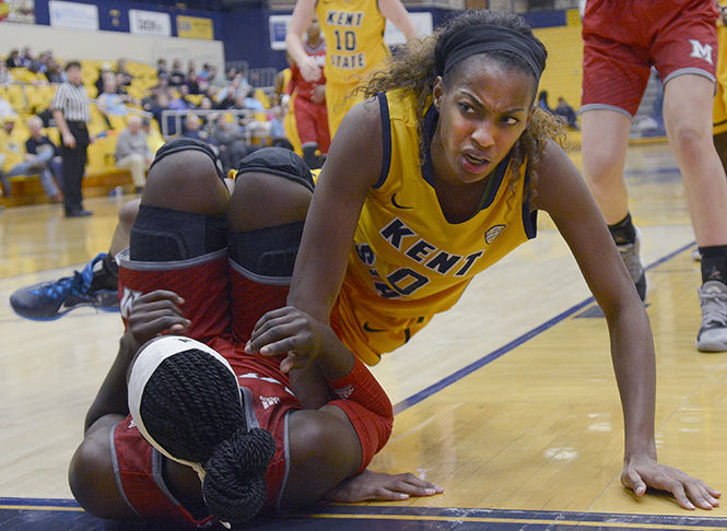 Kent State redshirt senior center CiCi Shannon lands on top of a Miami defender after missing a rebound in the M.A.C. Center on Wednesday, Feb. 11, 2015. The Flashes were down by just 6 points at the half, but fell flat during the second half and fell to RedHawks 69-53, dropping their record to 3-19.