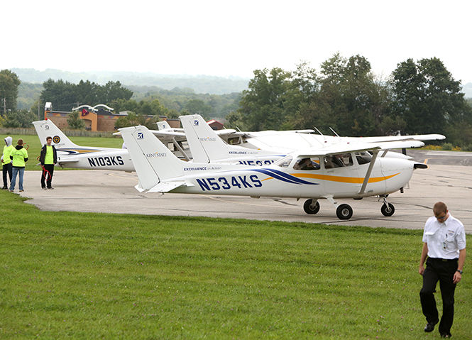 The Kent State University fleet of cessnas prepares to take visitors to the Aviation Heritage festival at the Kent State Airfield on tours up into the sky on Sept 13, 2014.