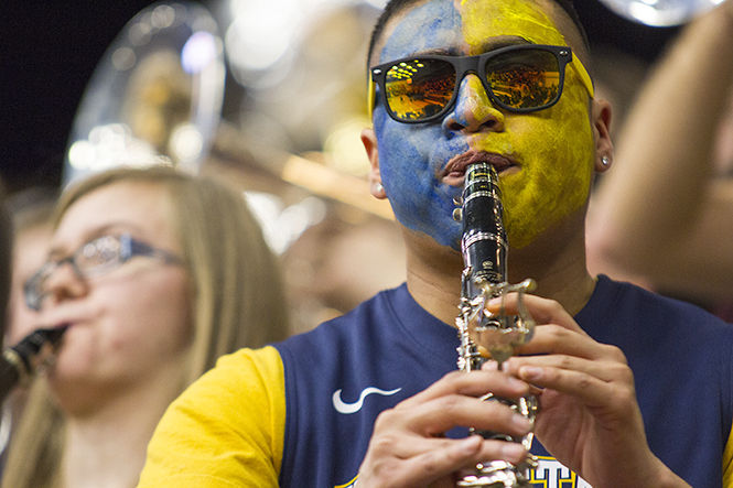Sophomore George Bagoy plays the clarinet during Kent States basketball game against Buffalo on Saturday Feb. 28, 2015. The Flasherbrass Basketball Band consists of woodwinds, brass, bass guitar and a rhythm section.