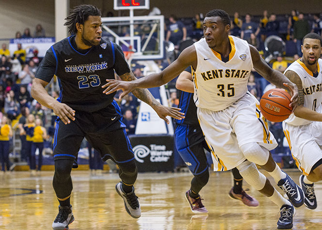 Kent player, Jimmy Hall, dribbles around a Buffalo player during a game on Saturday Feb. 28, 2015. Kent State lost the game 71-65.