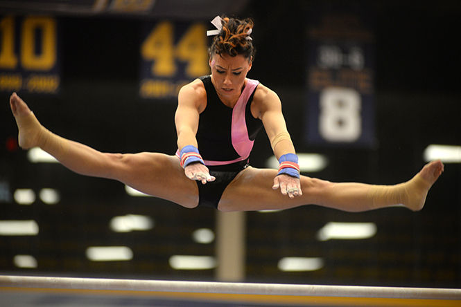 Kent State’s Rebecca Osmer warms up on the uneven bars during the Flip for the Cure meet against George Washington University on Sunday, Mar. 1, 2015. Osmer finished her routine with an overall score of 9.700 and the Flashes won 195.700-193.725.