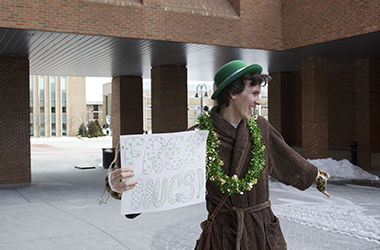 Since about mid-January, Christopher Mosquera has been strolling around campus every day wearing the same brown fuzzy bathrobe, leprechaun hat and St. Patrick’s Day tinsel around his neck.