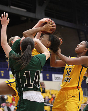 Kent State redshirt senior center CiCi Shannon tries to hold onto the ball through tough Ohio University defenders during their game in the M.A.C. Center on Wednesday, March 4, 2015. 