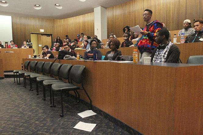 Matthew Thompson, president of Black United Students, addresses diversity and racial concerns to Undergraduate Student Government in the Governance Chambers of the Student Center on Wednesday, March 4, 2015. After finishing each page of his notes, Thompason threw it onto the floor of the chamber.